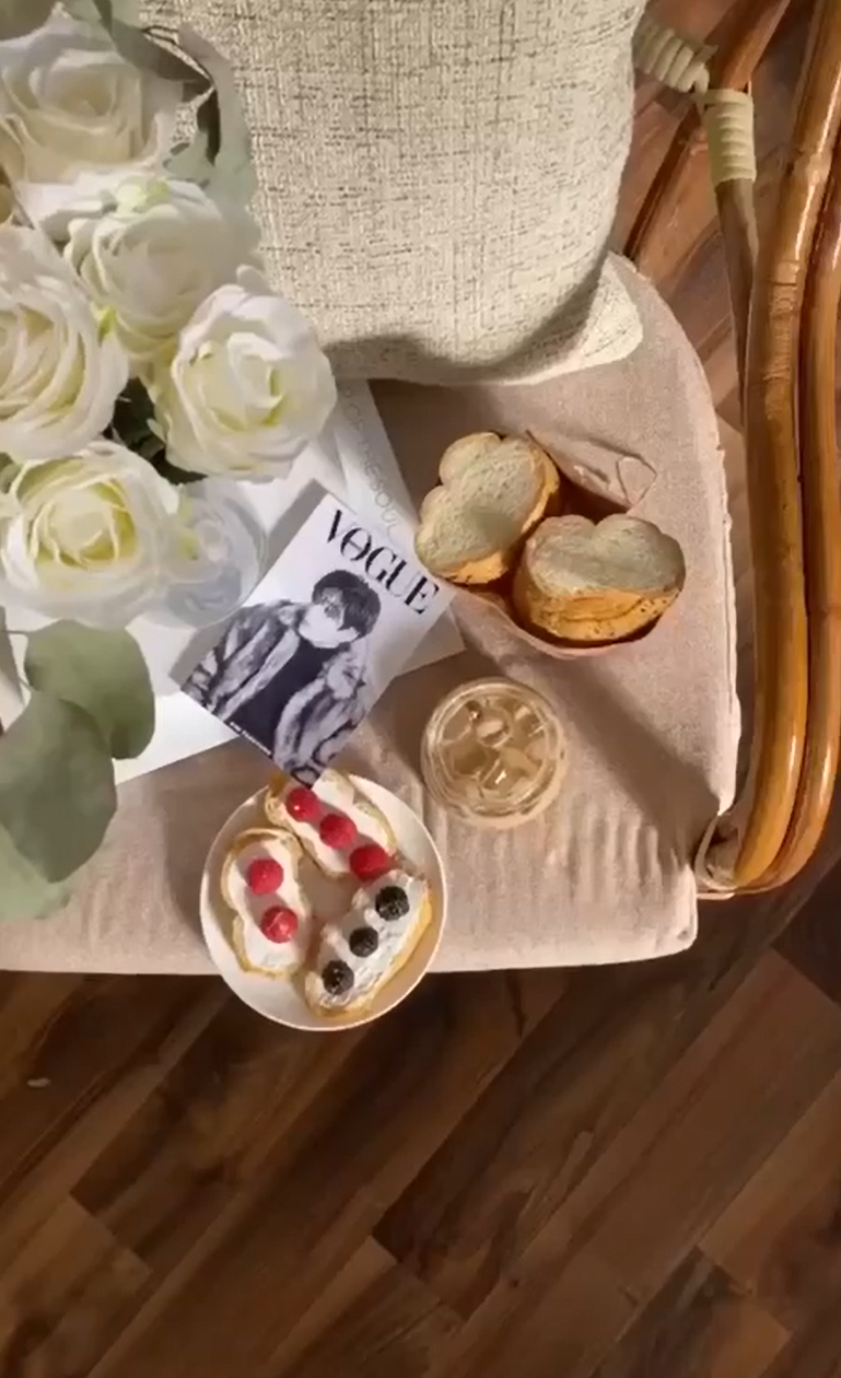 Cozy breakfast flat lay with heart-shaped bread and berries