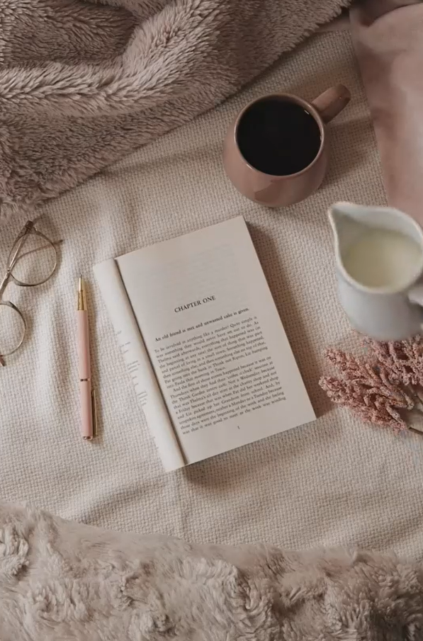 Cozy reading flat lay with coffee and milk in a copper mug