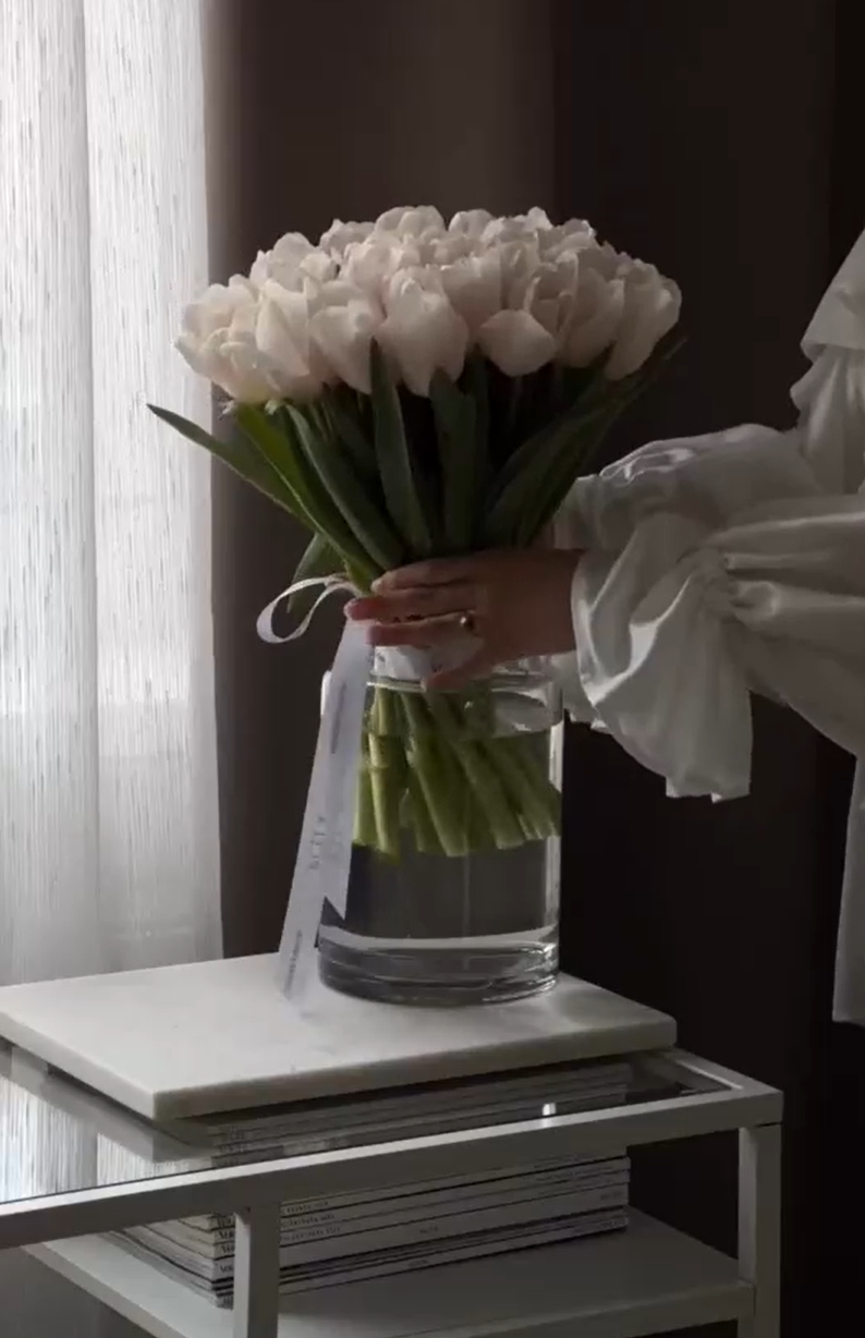 Elegant coffee moment with cream, tulips and perfume