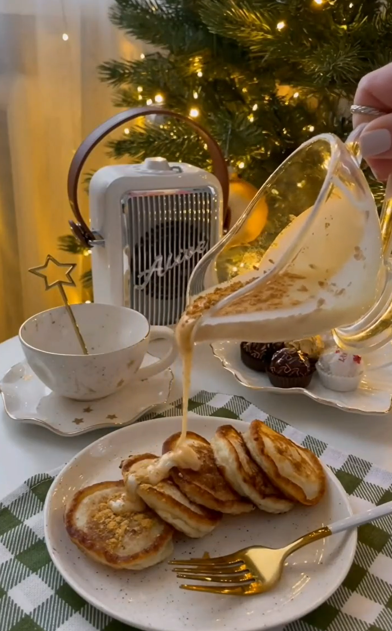 Festive mini pancakes with sauce by the Christmas tree