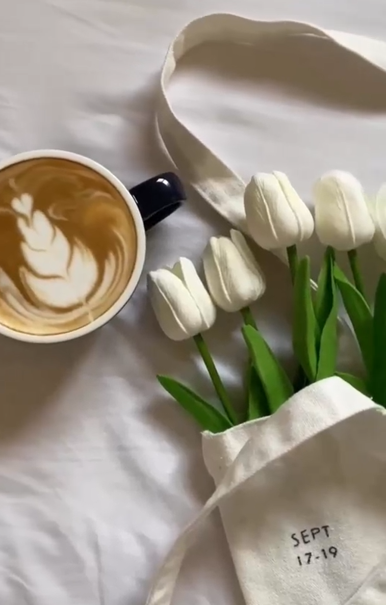 Latte art with white tulips in a canvas tote