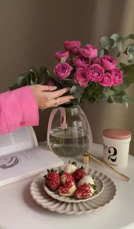 Lighting and extinguishing a candle with roses and chocolate-covered strawberries