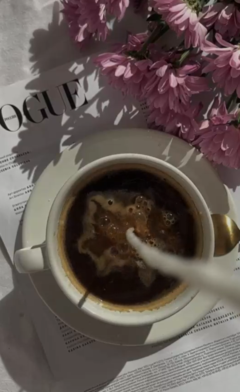 Pouring milk into coffee with flowers