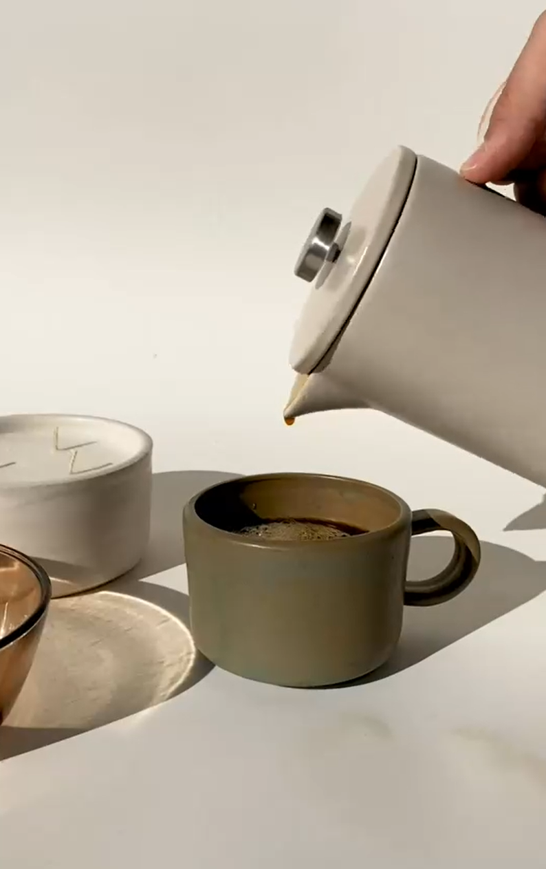 pouring coffee and milk stirring outside minimalistic