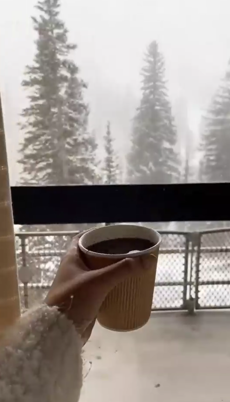 takeaway coffee on balcony while snowing